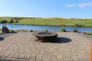 stone fire pit on stone paver patio with a beautiful view